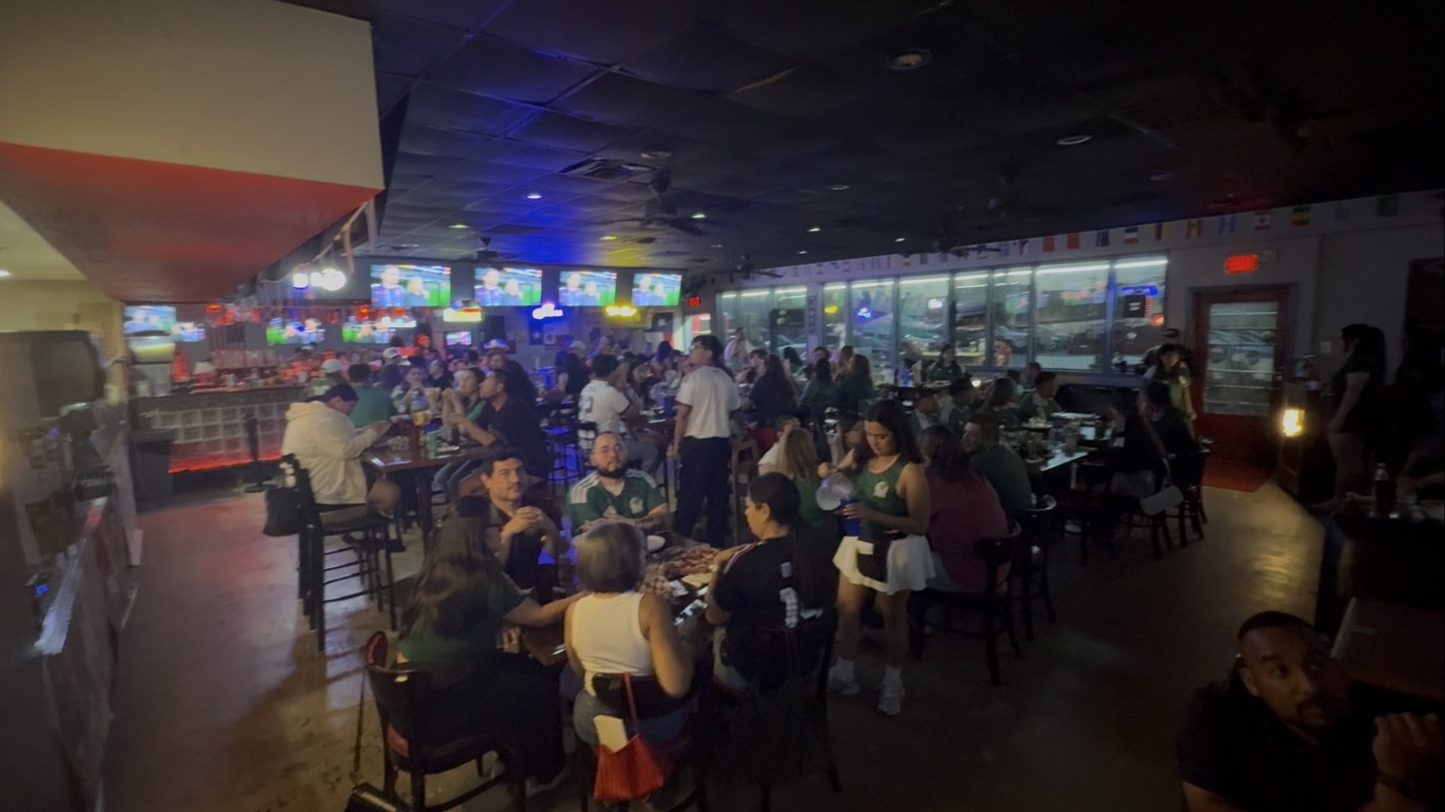Wall-to-wall crowd at Good Times with every screen on the match